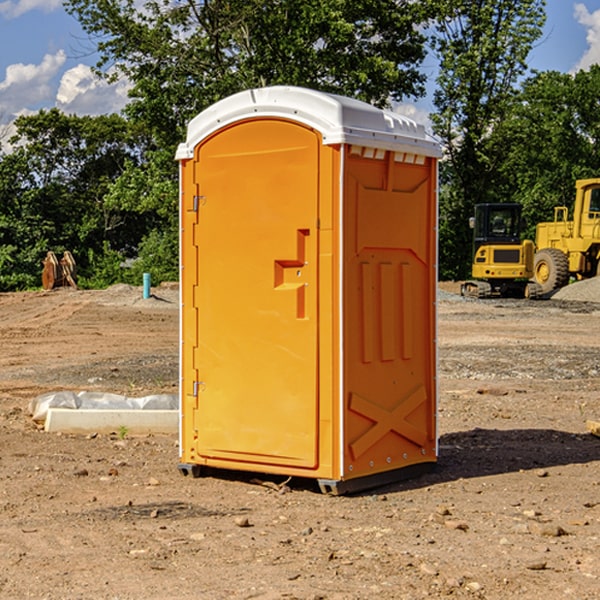 what is the cost difference between standard and deluxe porta potty rentals in Flora